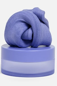 Speks Blur Calming Focus Putty in Twilight on top of its storage container.