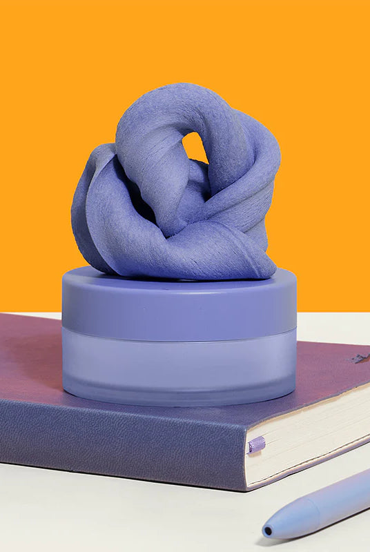 Speks Blur Calming Focus Putty in Twilight purple inside its storage container.