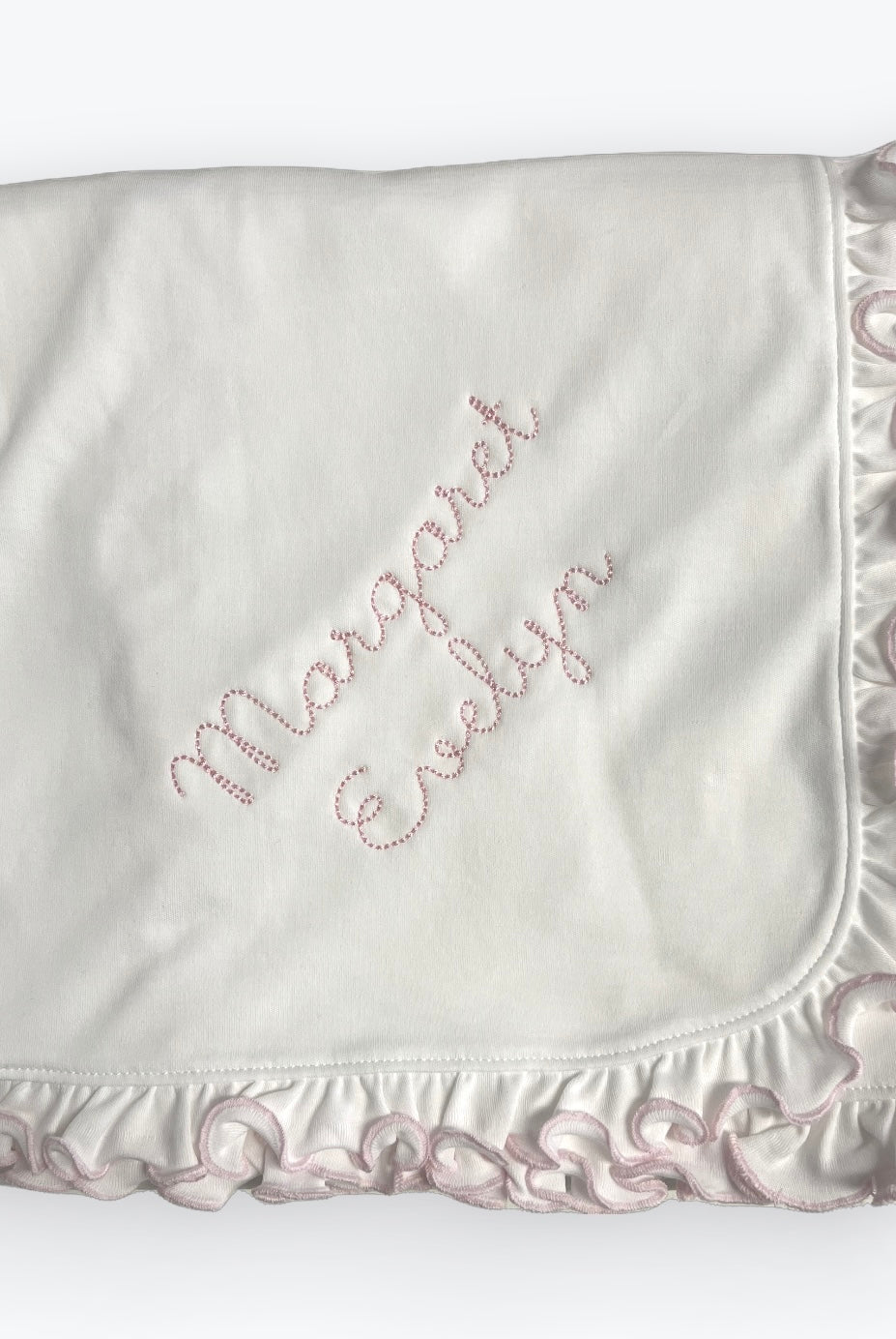 Personalized Pima cotton baby blanket with pink ruffle edge and custom name embroidery