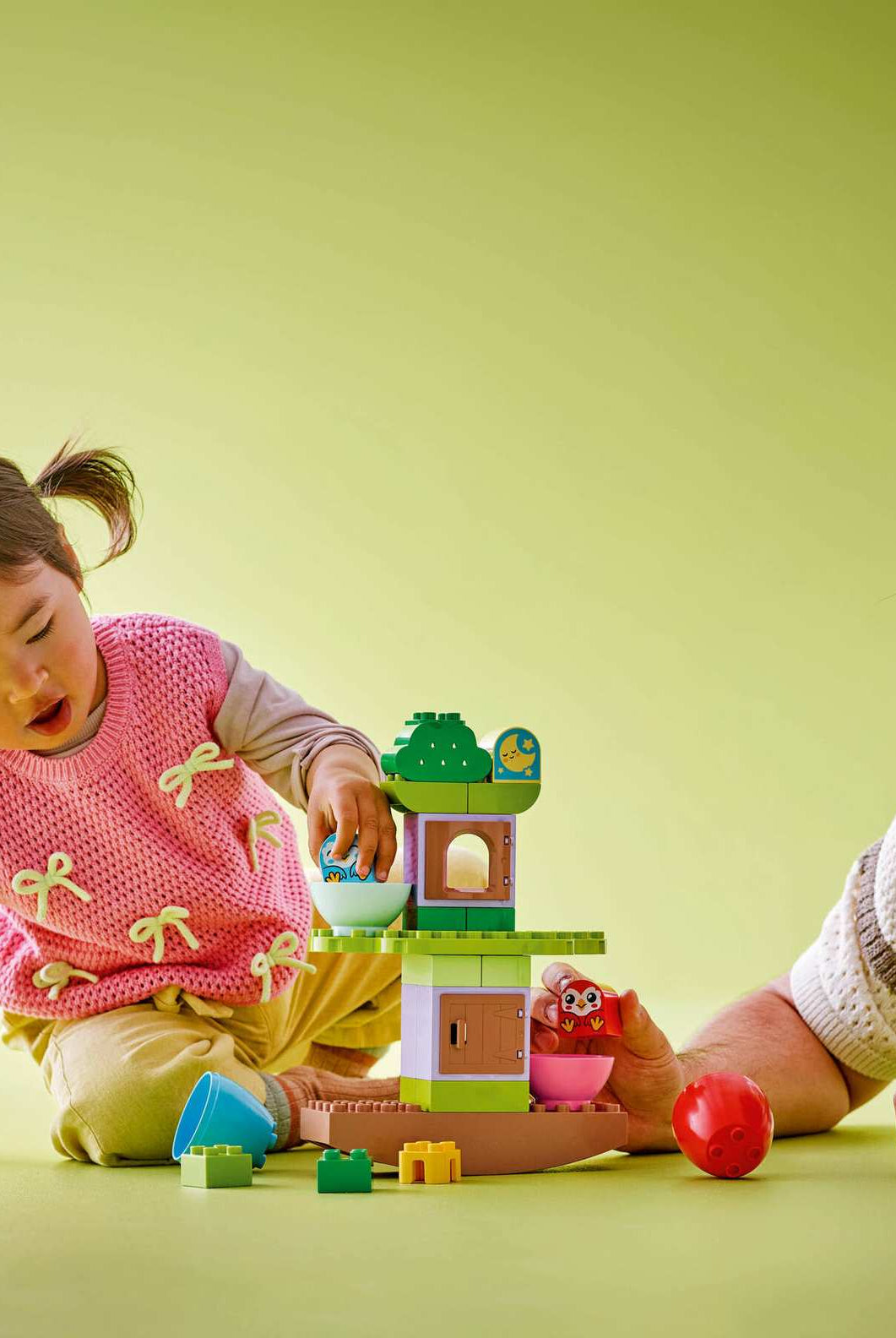Child playing with Lego Duplo 10440 Balancing Tree