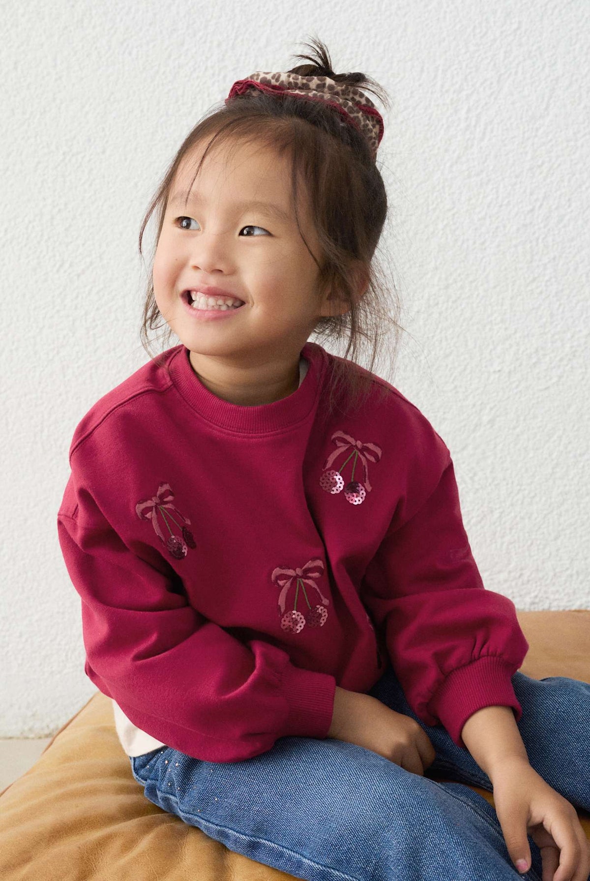 Girl wearing cherries sweatshirt