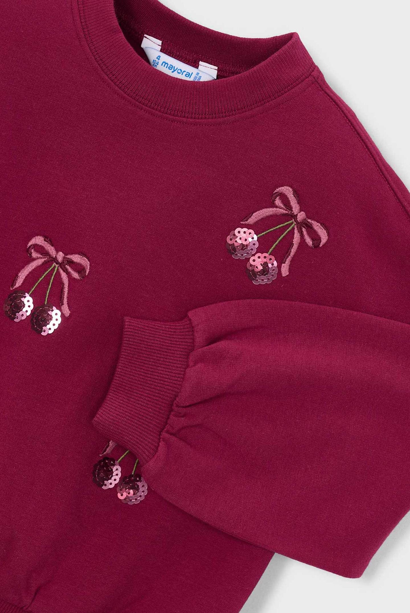 close up of cherries embroidery details