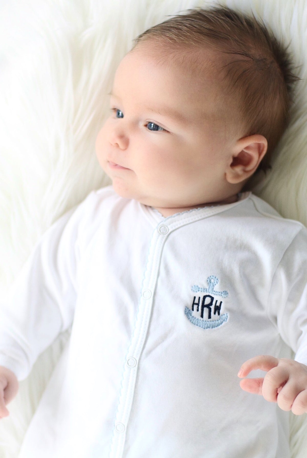 Personalized Pima cotton baby footie with blue picot trim and embroidered anchor monogram