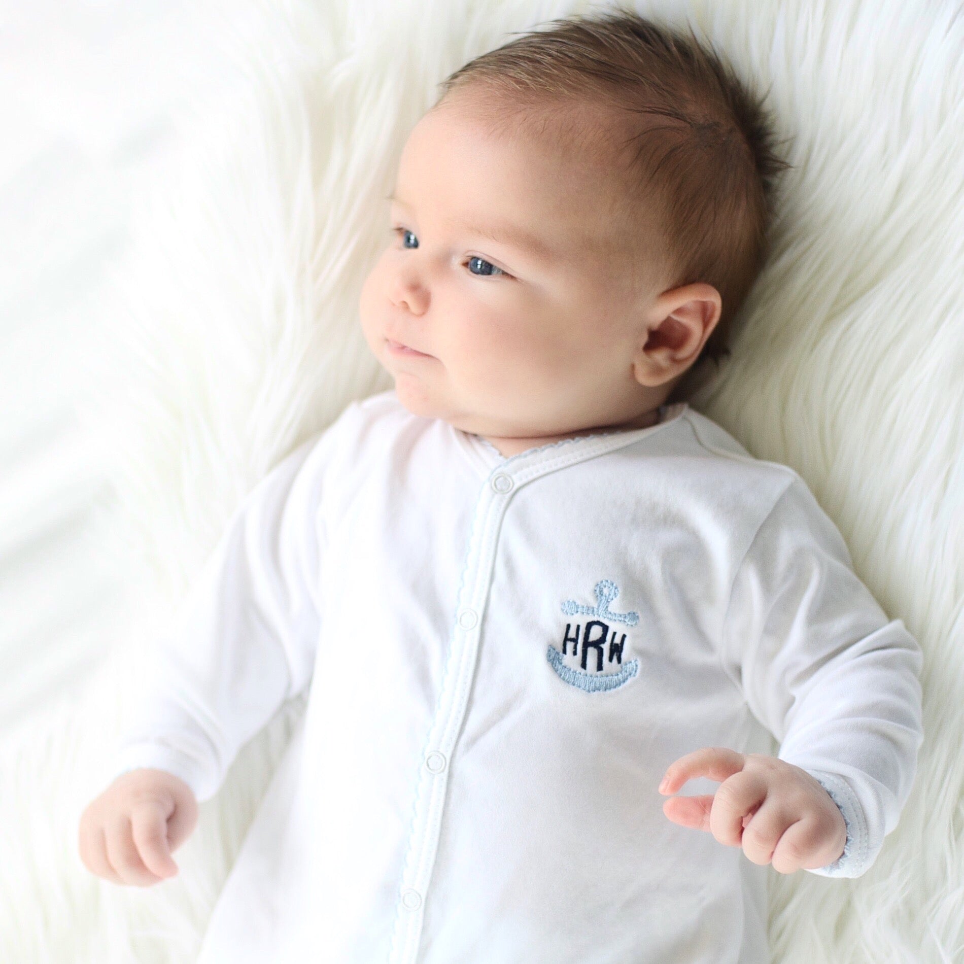 Personalized Pima cotton baby footie with blue picot trim and embroidered anchor monogram