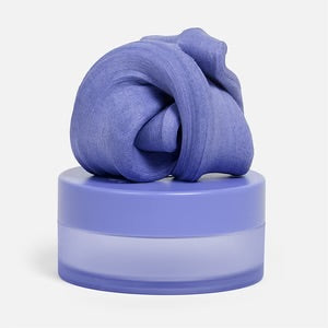 Speks Blur Calming Focus Putty in Twilight on top of  its storage container.