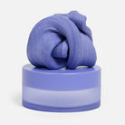 Speks Blur Calming Focus Putty in Twilight on top of  its storage container.