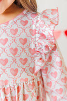 Close up of heart print pattern on toddler girl dress