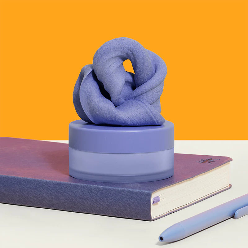 Speks Blur Calming Focus Putty in Twilight purple inside its storage container. 
