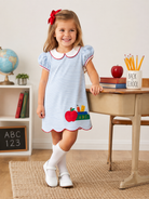 Todder Girl wearing a back to school dress with apple appliqué 