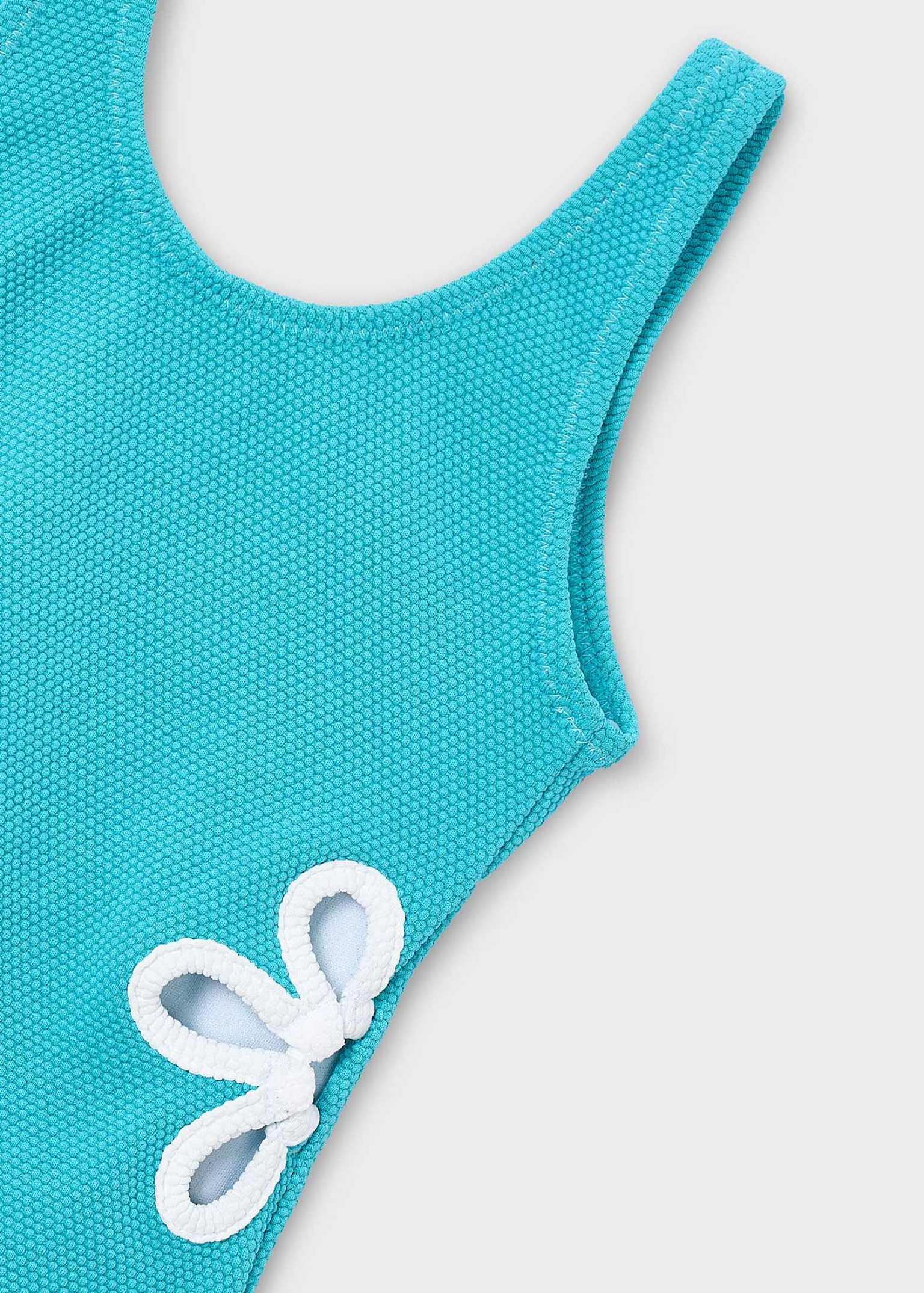 Closeup detail of Mayoral girls pacific blue one piece swimsuit with flower cutouts
