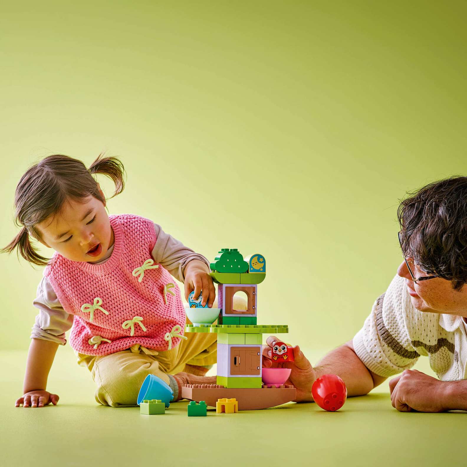 Child playing with Lego Duplo 10440 Balancing Tree