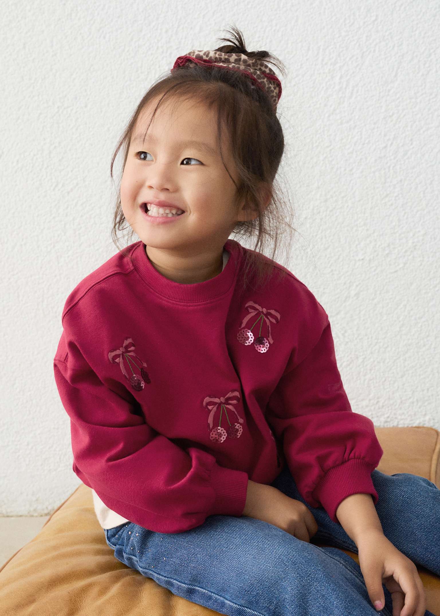 Girl wearing cherries sweatshirt 
