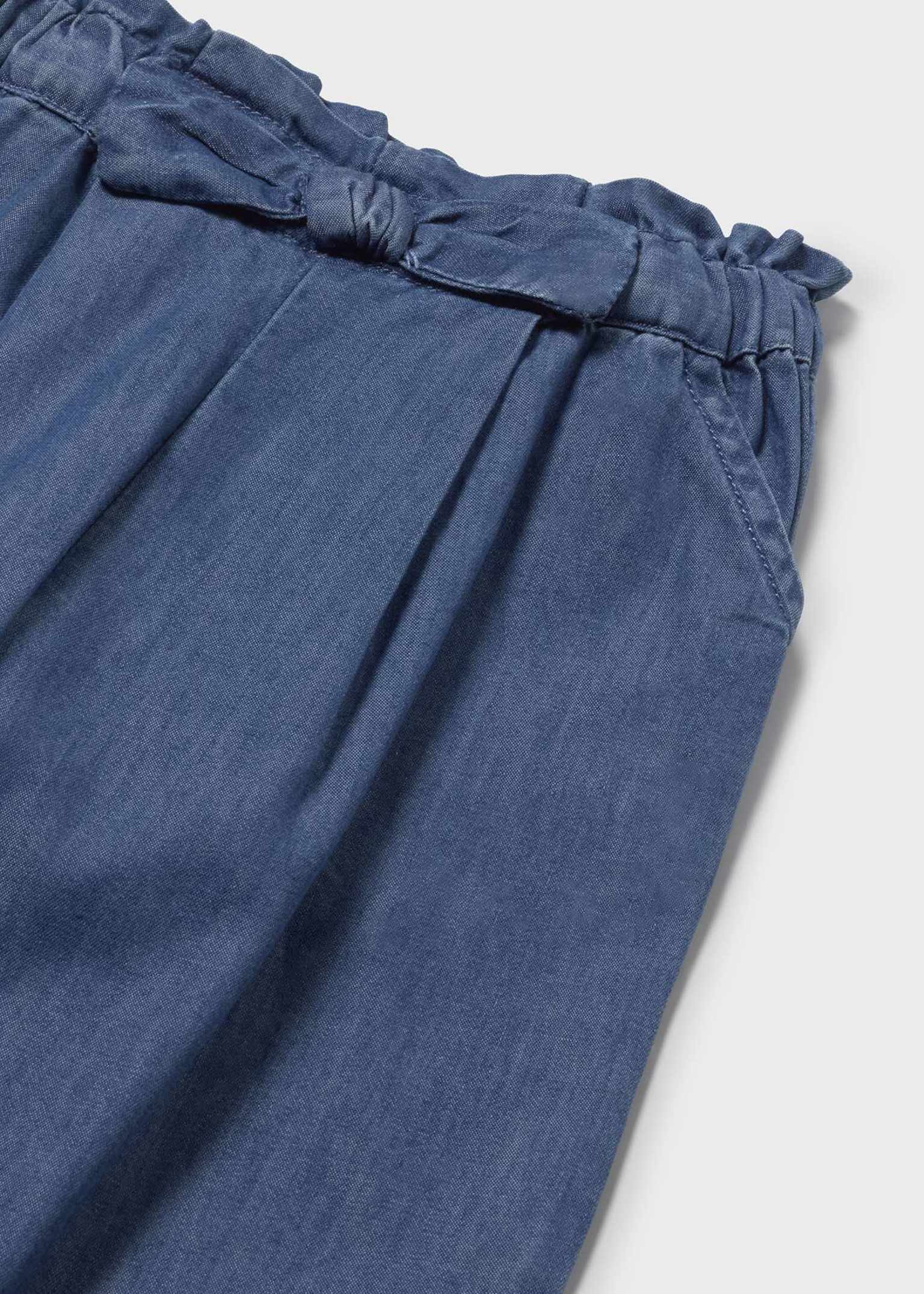 Close up of lightweight denim fabric on Mayoral girls flowy pants