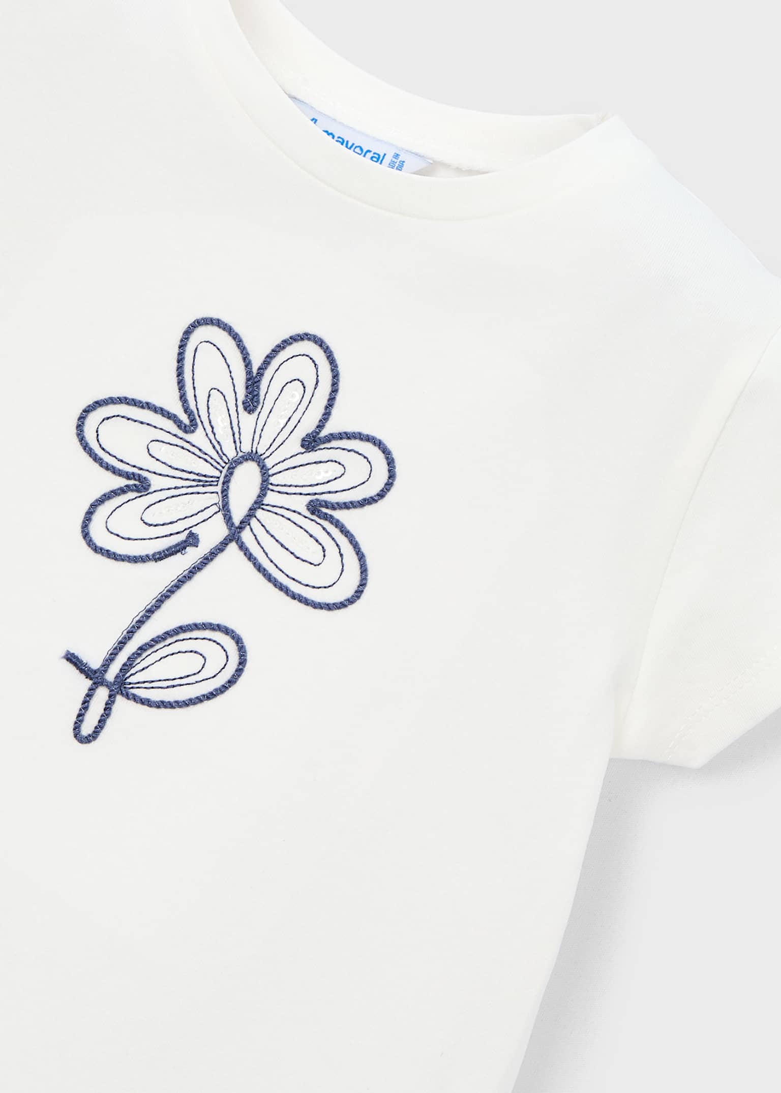 Navy floral embroidery detail on Mayoral cream girls top