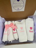 Personalized baby girl gift box with monogrammed burp cloths and bibs
